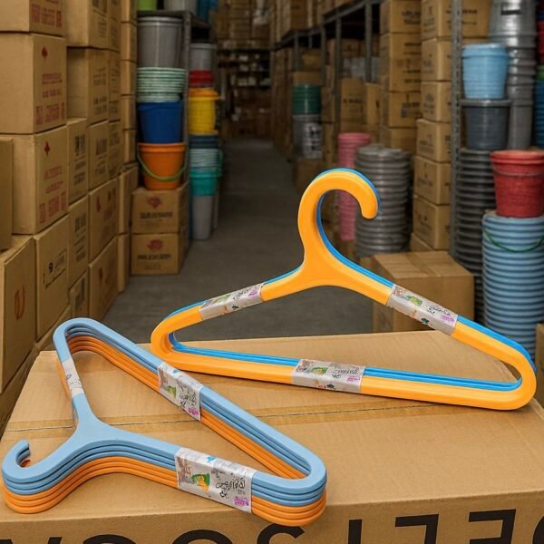 Stack of multi-color plastic hangers including yellow, blue, white, and orange for wardrobe organization