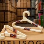 Stack of multi-color plastic hangers including yellow, blue, white, and orange for wardrobe organization