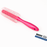 A pink paddle-style Maggie hair brush with white bristles and red tips, attached to a product tag reading “For Smooth & Stylish Hairs.”