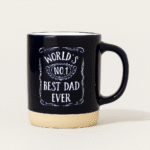 Ceramic mug with “World’s No.1 Best Dad Ever” printed in white on a black surface with beige bottom – gift mug for father