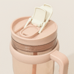 Leakproof sealed straw lid flipped open on pink cup