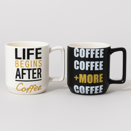 Set of two printed ceramic mugs – one white with “Life Begins After Coffee” and one black with “Coffee + More Coffee” – stylish tea and coffee cups for gifting and daily use