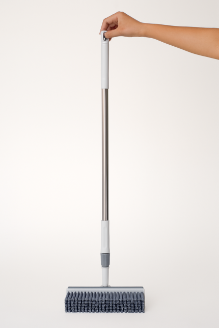 2-in-1 adjustable floor scrub brush with long handle held vertically by hand