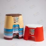 "Colorful plastic stools stacked and displayed for home, bathroom, or kitchen use – anti-slip, durable, and stackable design"