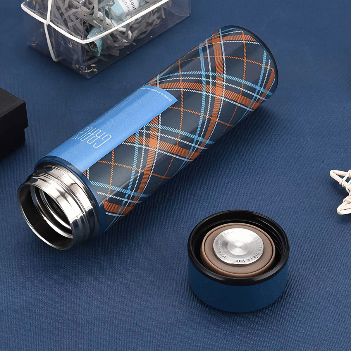 Four stylish smart LED thermos bottles in plaid designs with digital temperature displays showing 28°C, labeled GRACE, LIVELY, SWEET, and CHAR