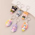 "Colorful multi-character cartoon key ring with cute figures attached to a metal keychain loop"