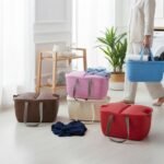 Family picnic using various colored Universal Carry Basket organizers in an outdoor setting.