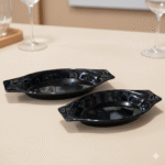 Two black melamine serving trays filled with creamy and pesto pasta, placed on a beige table — durable, heat-resistant, and elegant tableware for serving food in homes, restaurants, and cafes across Pakistan.