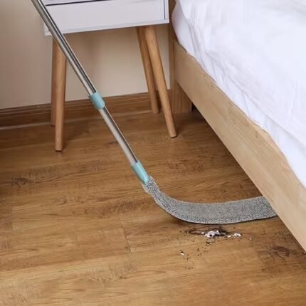 Flexible bendable flat microfiber mop cleaning under the bed and sofa in a Pakistan home