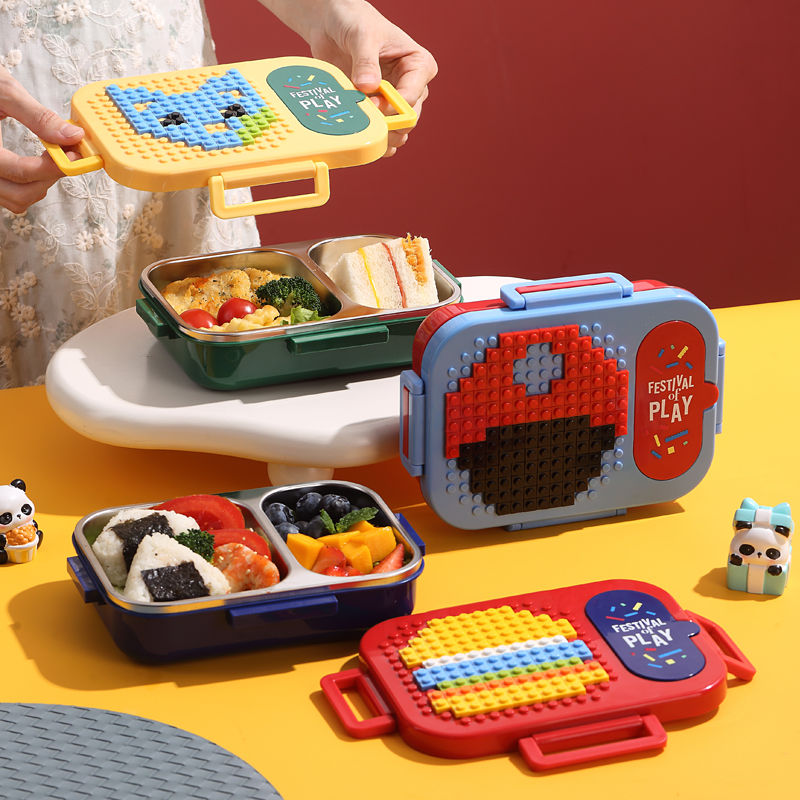 kids-lunch-box-steel-building-block-lid-pakistan.jpg Kids lunch box with stainless steel compartments and a colorful building block style lid