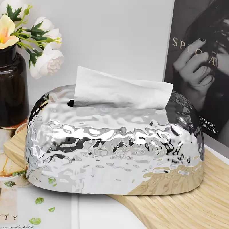 premium-textured-tissue-box-holder-plastic-pakistan.jpg Silver metallic finish plastic tissue box holder with hammered texture on wooden coffee table beside coffee mug