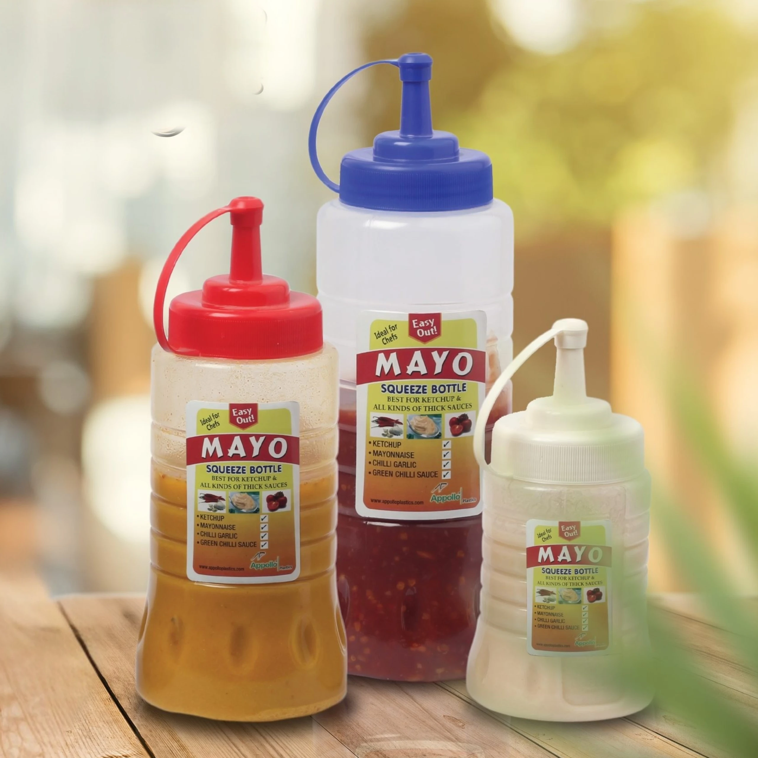 appollo-sauce-squeeze-bottle-pakistan.jpg Clear plastic sauce squeeze bottle with red flip-top nozzle cap, shown in three sizes